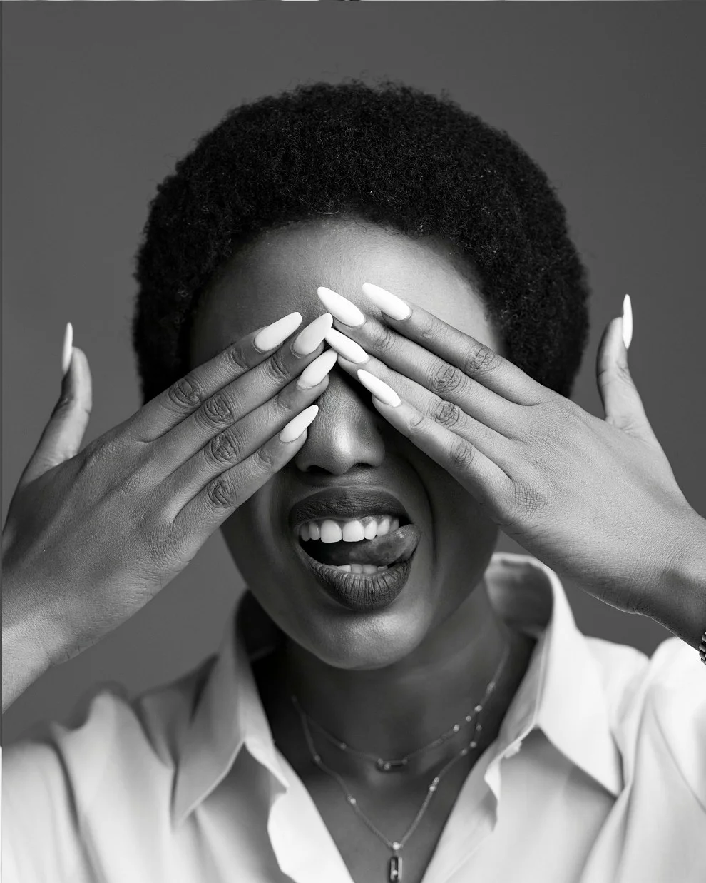 Nancy Isime covering her eyes, laughing