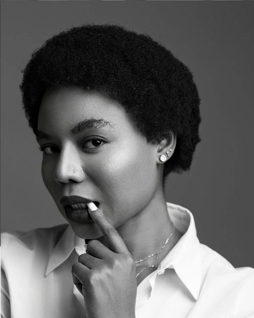 Nancy Isime thoughtful, finger to her lips